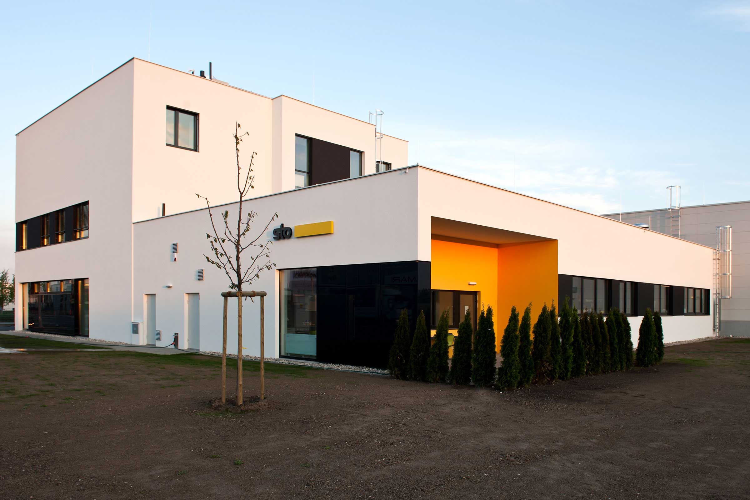 Exteriérový záběr prodejního centra Sto ve Vídni, Rakousko, bílá fasáda s logem Sto